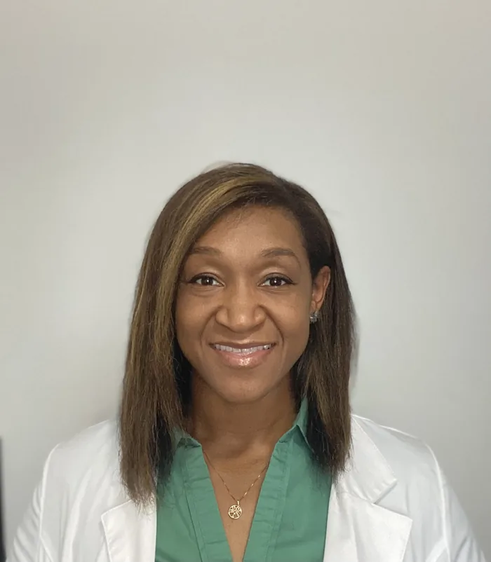 Lauren Bunch, a registered nurse and wellness coach, in a white coat